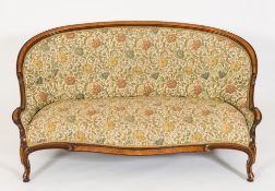 A Victorian carved walnut settee:, the curved upholstered panel back with moulded top rail,