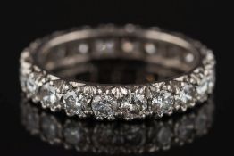 A diamond eternity ring: pave-set with twenty circular,