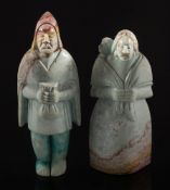 Two carved stone figures of a man and a woman,