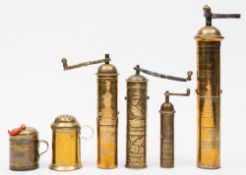 Four 19th century brass peppermills: of cylindrical form with hinged winding handles,