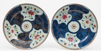 A pair of Chinese famille rose chargers: each of circular form decorated with six asymmetric panels