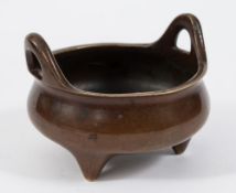 A Chinese bronze tripod censer: with loop handles to the rim, bears six character mark,
