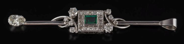 An emerald and diamond bar brooch converted to a pendant: with central rectangular emerald 5mm long