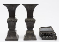 A pair of Chinese square-section bronze vases: of archaic Gu form, decorated with scrolling foliage,