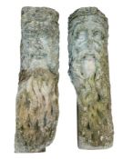 A pair of carved stone corbels:, decorated with bearded masks emblematic of Old Father Time,