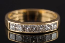 An 18ct gold and diamond seven-stone half hoop ring: with princess-cut diamonds estimated to weigh