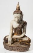 A large alabaster and polychrome decorated buddha statue: in traditional robes,