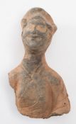 A Chinese pottery head and shoulders bust: of a smiling female wearing headdress,