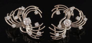 A pair of diamond cluster earrings: with clip fittings of open wirework spray design,