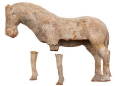 A small Chinese painted terracotta figure of a horse: standing four-square, Tang Dynasty,