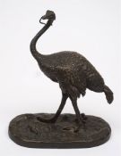 A late 19th century bronze model of an ostrich: holding a small snake in it's mouth,