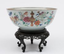 A Chinese porcelain bowl: the interior enamelled in the famille rose palette with peony and