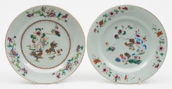 Two Chinese famille rose decorated plates: each decorated with a pair of cockerels in a landscape