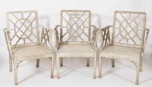 A rare set of twelve George II grey painted armchairs:,