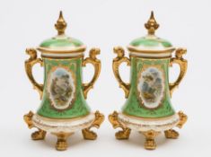 A pair of Coalport porcelain jars and covers: of tapering cylindrical form set on four lion paw