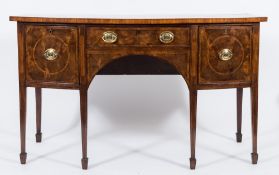 A George III mahogany crossbanded and inlaid bow fronted sideboard:,