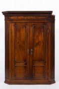 A late 18th century mahogany hanging corner cupboard:,
