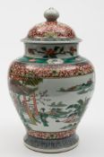 A Chinese porcelain baluster jar and domed cover: enamelled front and verso with panels containing