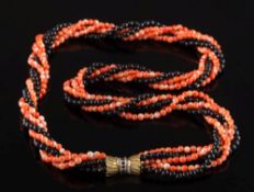 A coral and black bead rope necklace: with four coral and two black bead strings secured to a
