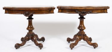 A pair of Victorian rosewood tea tables: of serpentine shaped outline,