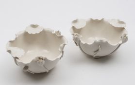 A pair of Chinese blanc de Chine Dehua lotus bowls: in the form of a lotus flower with applied buds,