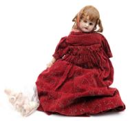 An Armand Marseille bisque head doll:, brown wig with brown glass sleeping eyes,