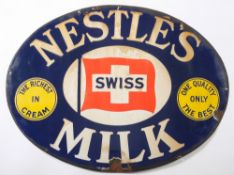 An oval enamel advertising sign for 'Nestles Swiss Milk':, white , blue, yellow and red enamels,