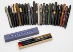 A collection of Waterman's fountain pens:, including a red marble 'Unique-Junior', a '512M',