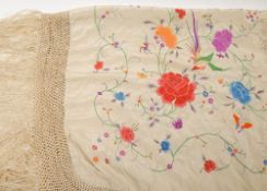 A Victorian cream silk and floral embroidered shawl:, with tassel fringe,