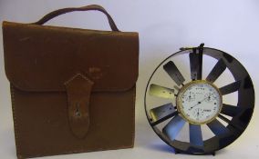 A lacquered brass and anodised metal anemometer: with central gauge and rotating vane,