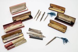 A collection of silver and silver plated propelling pencils and pencil holders:,