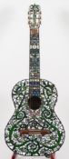 An acoustic guitar, Rioji Matsuuka Luther, model number 20 in mosaic veneered case.