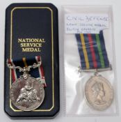 An Elizabeth II Civil Defence Long service medal and a national Service medal in case:.