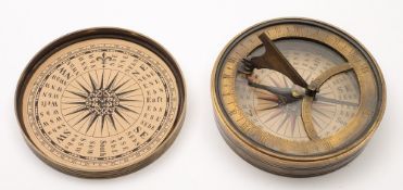A circular brass pocket sundial compass:, unsigned, 3 inch paper dial in a turned case.