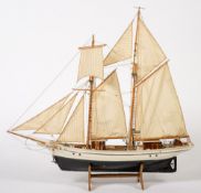 A scale model of a trawler:, fully rigged over planked deck with wheelhouse, davits and lifeboat,