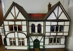 An Edwardian dolls house, in the mock Tudor-style: with hinged double front,