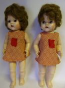 Two composition walking dolls: with weighted blue eyes, open mouth with two upper teeth, 53cm. high.