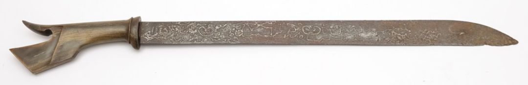 An Indonesian short sword (Mandu):, the single edged Damascus blade with carved horn handle,