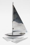 A silver everlasting match in the form of a yacht:, 35cm high .