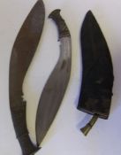 A Malayan Kukri of traditional design: in leather scabbard, together with another kukri, (2).