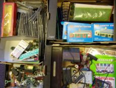 A collection of plastic trackside buildings: scenic materials figures, card building kits,