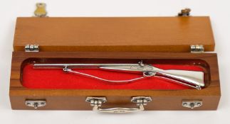 A miniature white metal double barrel shotgun in case:,