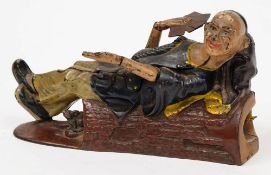 A Reclining Chinaman cast iron money bank by J E Stevens:,
