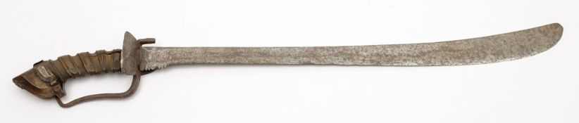 An Indonesian short sword:, the slightly curved single edged blade with broad back,
