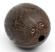 An 18th century bug bear:, of typical form with glass eyes over an open mouth and carved face,