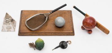 A group of five early 20th century novelty inkwells:, comprising a cricket bat and ball,
