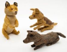 A blonde plush fox by Steiff, together with two similar dogs:, the former with glass eyes,