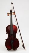 A 19th century student violin in case with bow:, both unsigned, the violin with scroll headstock ,