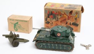 A post war West German clockwork tinplate tank by Arnold, and a Britains 25 pdr Howitzer:,