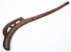 A native carved wooden club in the form of a lizard:,